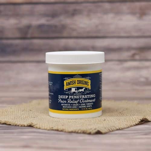 A 14 oz container of Amish Origins Deep Penetrating Pain Relief Ointment, set on rustic burlap with a wooden background.