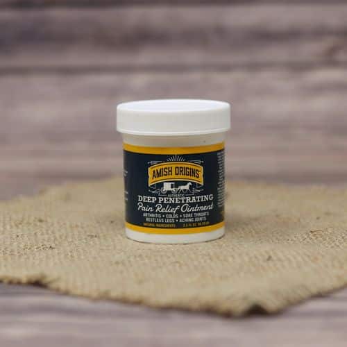 A 3.5 oz container of Amish Origins Deep Penetrating Pain Relief Ointment, set on rustic burlap with a wooden background.