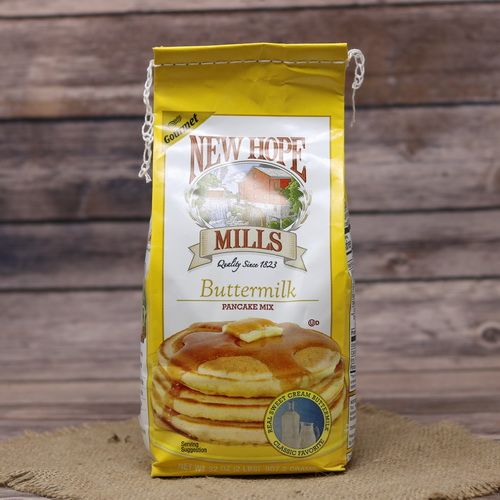 A bag of Buttermilk Pancake Mix on rustic burlap with a wooden background.