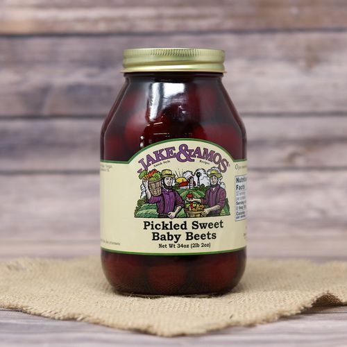 A quart size glass jar of Jake & Amos Pickled Sweet Baby Beets, on rustic burlap with a wooden background.