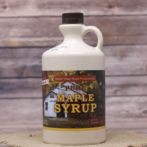 A half gallon bottle of Pure Ohio Maple Syrup, set on rustic burlap with a wooden background.