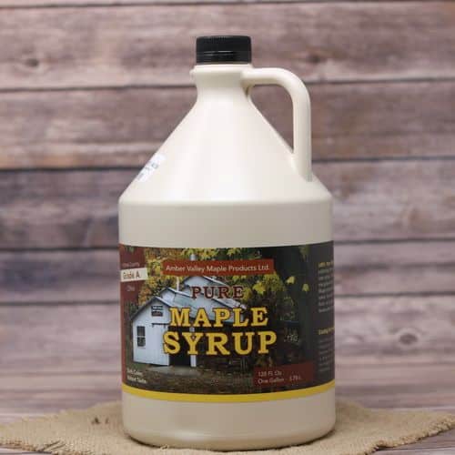 A gallon jug of Pure Ohio Maple Syrup, set on rustic burlap with a wooden background.