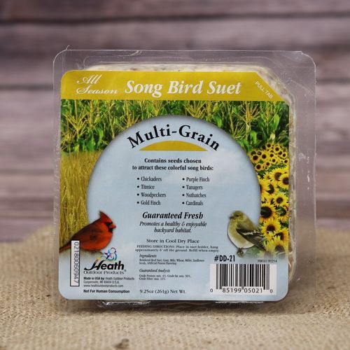 A square package of Multi Grain Suet Cake on rustic burlap with a wooden background.