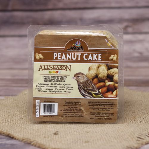 A square package of Peanut Cake Suet Cake on rustic burlap with a wooden background.