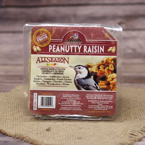 A square package of Peanutty Raisin Suet Cake on rustic burlap with a wooden background.