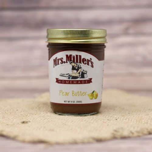 A 9 oz glass jar of Mrs. Miller's Pear Butter, on rustic burlap with a wooden background.