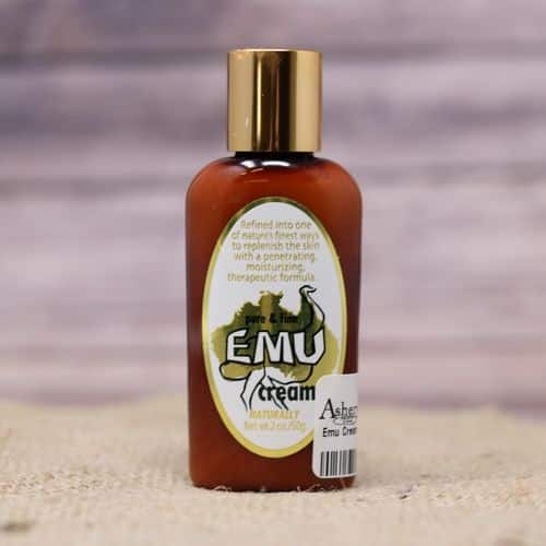 A bottle of Emu Cream, set on rustic burlap with a wooden background.