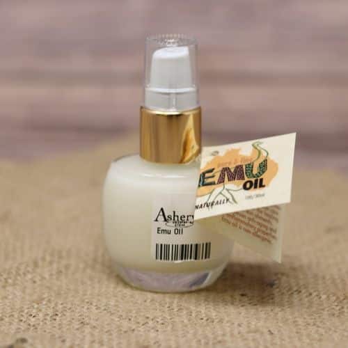 A glass pump bottle of Emu Oil, set on rustic burlap with a wooden background.