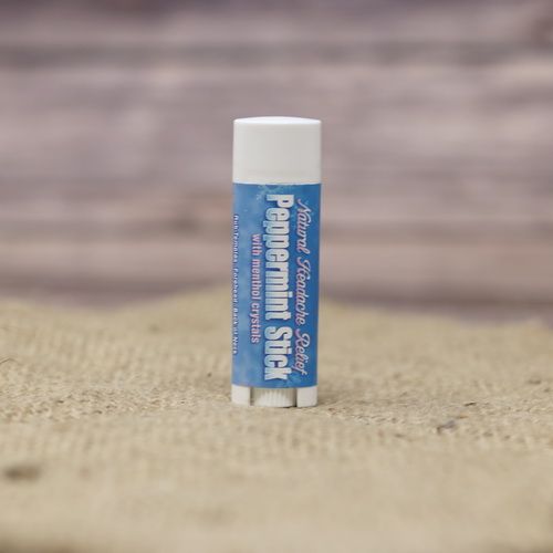 A headache relief peppermint stick, set on rustic burlap with a wooden background.