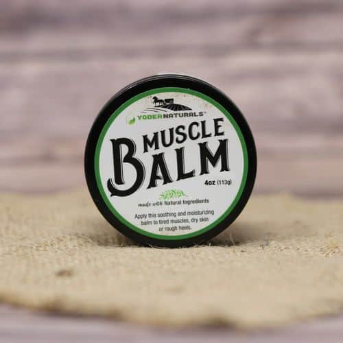 A 4 oz container of Yoder Naturals Muscle Balm, set on rustic burlap with a wooden background.