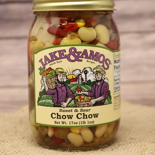 A pint size glass jar of Jake & Amos Sweet & Sour Chow Chow, on rustic burlap with a wooden background.