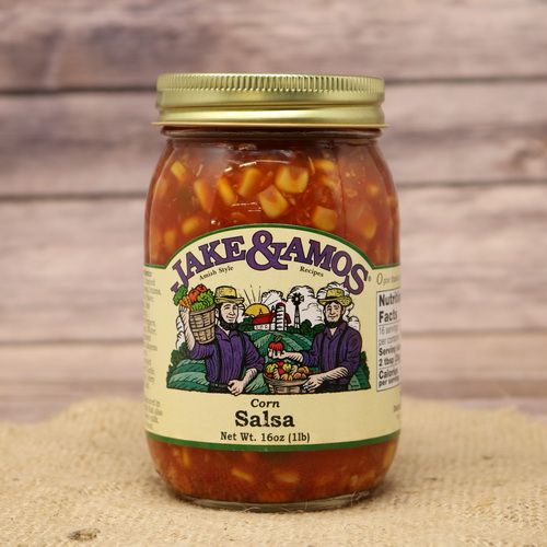 A pint size glass jar of Jake & Amos Corn Salsa, on rustic burlap with a wooden background.