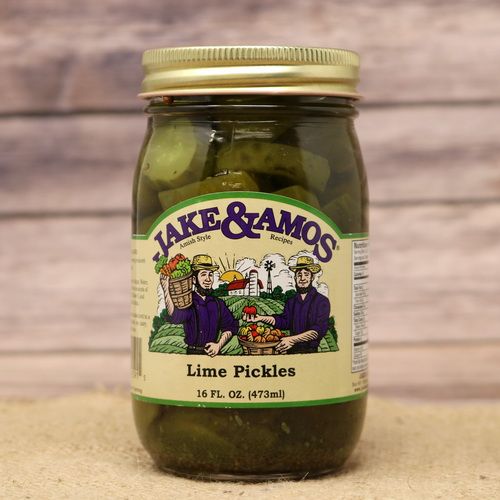 A pint size glass jar of Jake and Amos Lime Pickles, on rustic burlap with a wooden background.