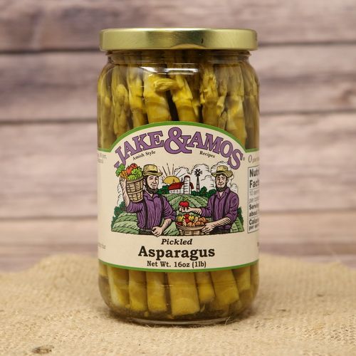 A pint size glass jar of Jake & Amos Pickled Asparagus, on rustic burlap with a wooden background.