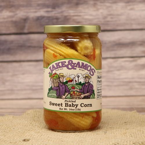 A pint size glass jar of Jake & Amos Pickled Sweet Baby Corn, on rustic burlap with a wooden background.