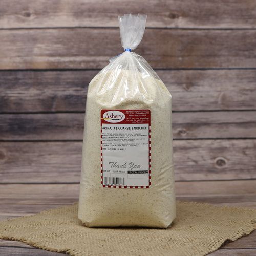 A clear plastic bag containing Farina on rustic burlap with a wooden background.