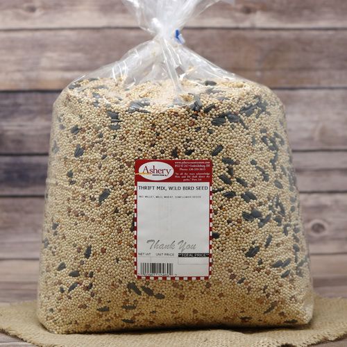 A large bag of Thrift Mix Wild bird Seed on rustic burlap with a wooden background.