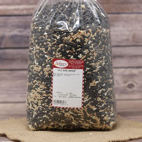 A large clear bag of Wild Bird Banquet on rustic burlap with a wooden background.