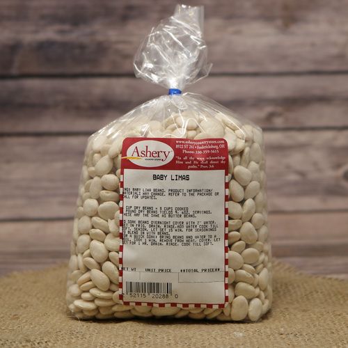 A bag of dried Baby Lima Beans sealed with a twist tie on rustic burlap and wooden background.