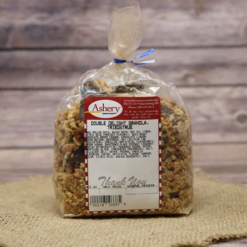 A clear bag of Double Delight Granola on rustic burlap with a wooden background.