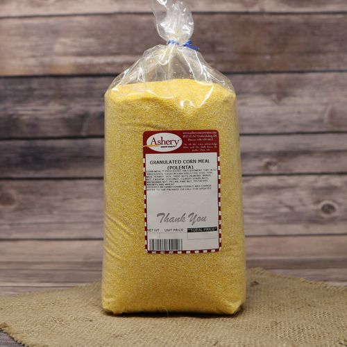 A bag of Granulated Cornmeal Polenta, sealed with a twist tie, on rustic burlap with a wooden background.