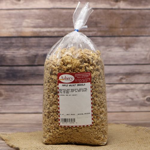 A clear plastic bag sealed with a twist tie containing Maple Walnut Granola on rustic burlap with a wooden background.
