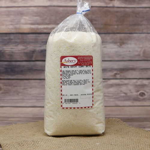 A bag of White Hominy Grits on rustic burlap with a wooden background.