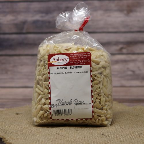 A clear plastic bag of Slivered Almonds, closed with a twist tie and set on rustic burlap with a wooden background.