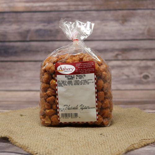 A clear plastic bag of Buffalo Peanuts, closed with a twist tie and set on rustic burlap with a wooden background.