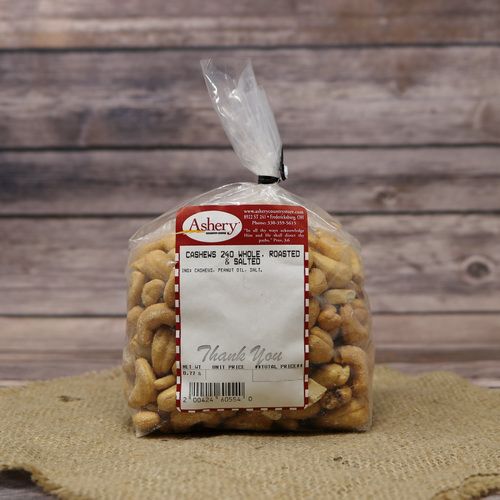 A clear plastic bag of Whole 240 Cashews Roasted & Salted, closed with a twist tie and set on rustic burlap with a wooden background.