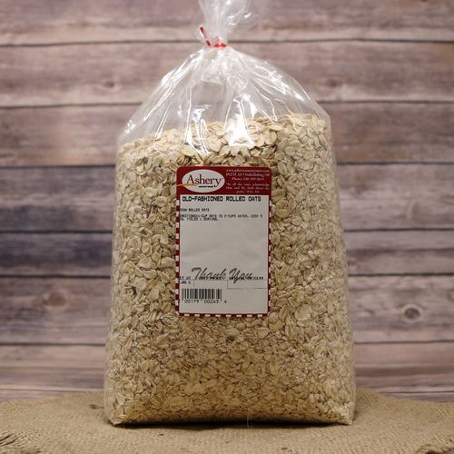 A bag of Old Fashioned Rolled Oats, sealed with a twist tie, on rustic burlap with a wooden background.