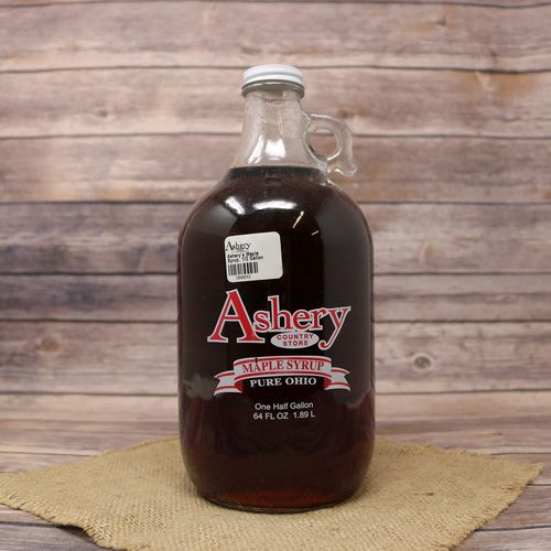 A half gallon glass bottle of Pure Ohio Maple Syrup, set on rustic burlap with a wooden background.