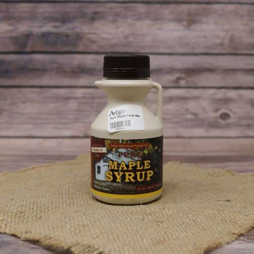An 8 oz size bottle of Pure Ohio Maple Syrup, set on rustic burlap with a wooden background.