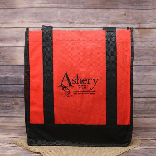 A red & black reusable bag with the Ashery logo, on rustic burlap with a wooden background.
