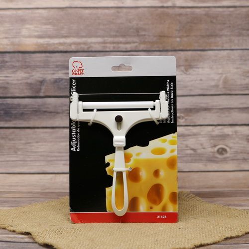 A Chef Craft Cheese Slicer, on rustic burlap with a wooden background.