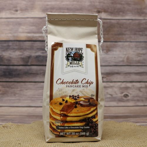 A light brown bag of Chocolate Chip Pancake Mix on rustic burlap with a wooden background.