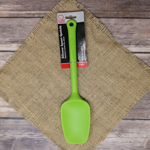 A Chef Craft green Silicone Spoon Spatula, laying on rustic burlap with a wooden background.