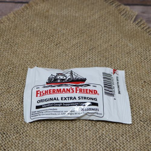 A package of 20 Fisherman's Friend Cough Lozenges, set on rustic burlap.