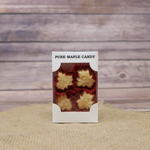 A box of Pure Maple Leaf Candy, set on rustic burlap with a wooden background.