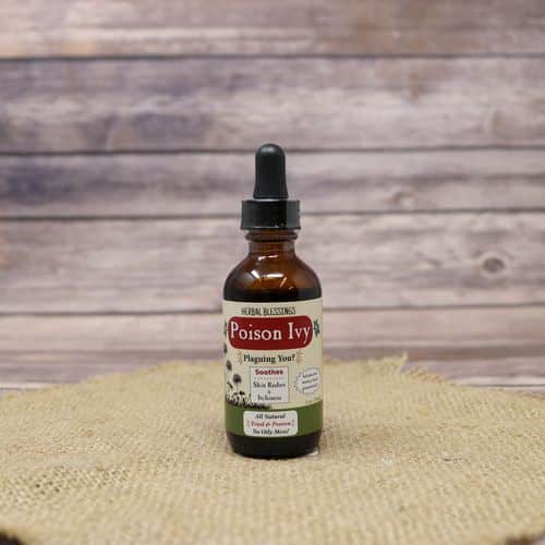 A 2oz dropper bottle of Poison Ivy Oil, set on rustic burlap with a wooden background.
