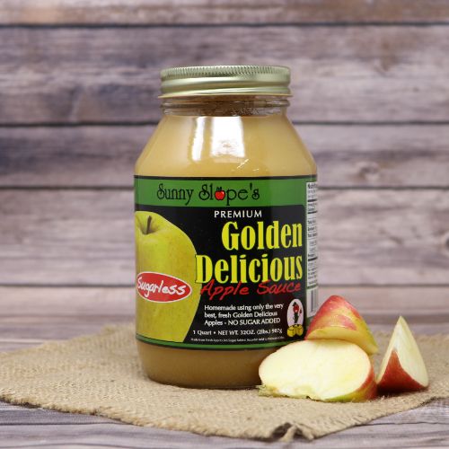 A quart size glass jar of Sunny Slope Orchards Sugarless Golden Delicious Apple Sauce, on rustic burlap with a wooden background.