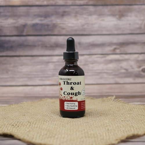A 2oz dropper bottle of Herbal Blessings Throat & Cough Syrup, set on rustic burlap with a wooden background.