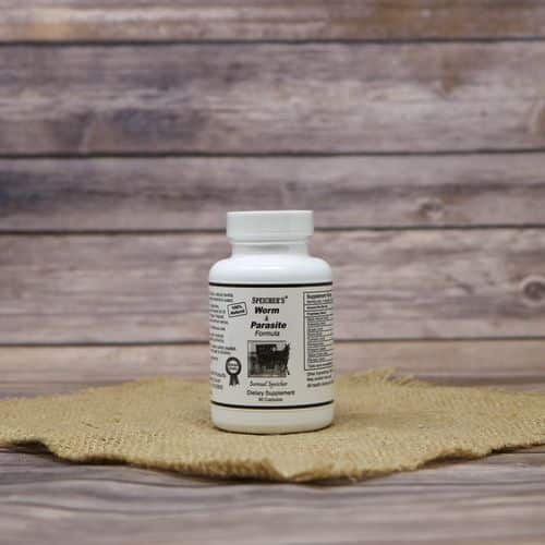 A 90 capsule bottle of Specicher's Worm & Parasite Formula, set on rustic burlap with a wooden background.
