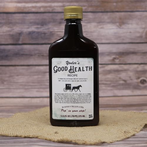 A 12.5 oz bottle of Yoder's Good Health Recipe, set on rustic burlap with a wooden background.