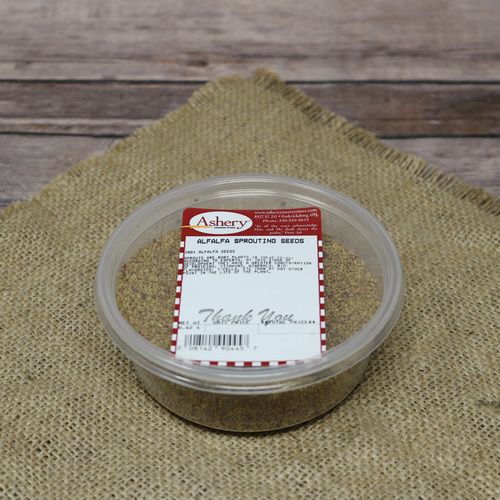 A round plastic container of Alfalfa Sprouting Seeds, set on rustic burlap with a wooden background.