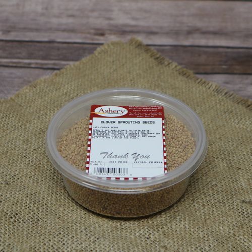 A round plastic container of Clover Sprouting Seeds, set on rustic burlap with a wooden background.