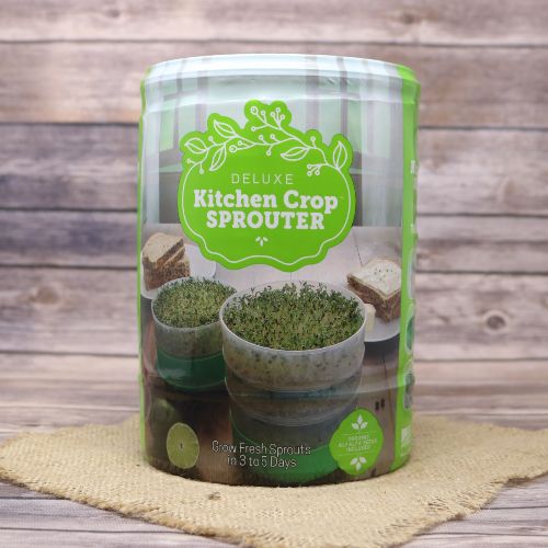 A kitchen Crop Sprouter for growing fresh sprouts, on rustic burlap with a wooden background.