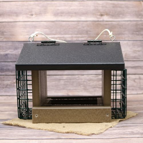 A Poly Bird feeder with two suet bins, sitting on a burlap material with wood background.