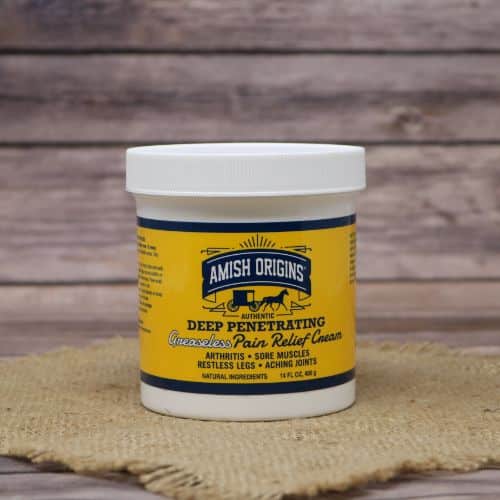 A 14 oz container of Amish Origins Greaseless Pain Relief Cream, set on rustic burlap with a wooden background.