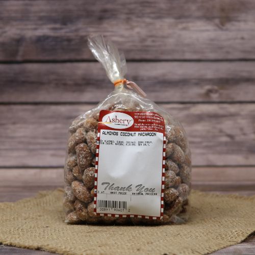 A plastic bag of Coconut Macaroon Almonds, closed with a twist tie and set on rustic burlap with a wooden background.